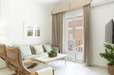 a living room with a couch and a table at Amplio apartamento en Playa de Regla. 2. in Chipiona