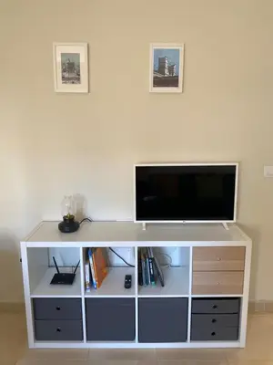 a white entertainment center with a flat screen tv on it at Penthouse in the center in Cádiz