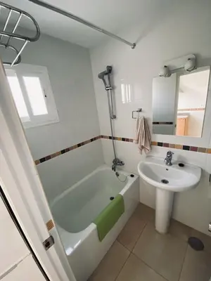 a bathroom with a sink and a tub and a toilet and a sink at Penthouse in the center in Cádiz
