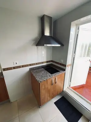 a kitchen with a sink and a stove at Penthouse in the center in Cádiz