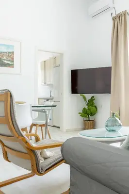 a living room with a couch and a table at Apartamento coqueto en la Playa de Regla. 4. in Chipiona