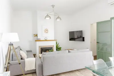 a living room with a couch and a fireplace at Precioso apartamento con Chimenea patio solarium. in Chipiona