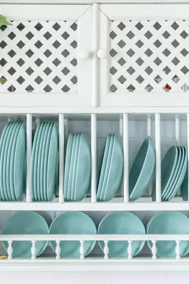 a cupboard filled with blue plates and bowls at Precioso apartamento con Chimenea patio solarium. in Chipiona