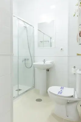 a bathroom with a toilet and a sink and a shower at Apartamento Playa de Regla con terraza. 1. in Chipiona