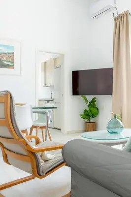 a living room with a couch and a table at Apartamento Playa de Regla con terraza. 1. in Chipiona