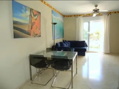 a living room with a glass table and a couch at CHIPIONA SOL Y PLAYA in Chipiona