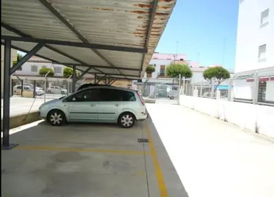 a small car parked in a parking lot at CHIPIONA SOL Y PLAYA in Chipiona
