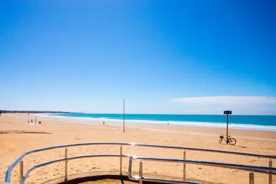 a view of a beach with a bike on the sand at La Barrosa con vistas al mar in Novo Sancti Petri