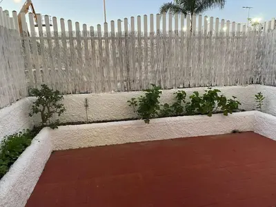 a garden with a fence and some plants at MyChoice Soleá in Rota