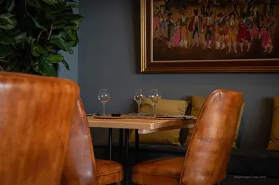 a dining room with a table and chairs with wine glasses at Hotel Jerez & Spa in Jerez de la Frontera