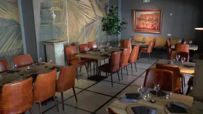 a dining room with wooden tables and chairs at Hotel Jerez & Spa in Jerez de la Frontera