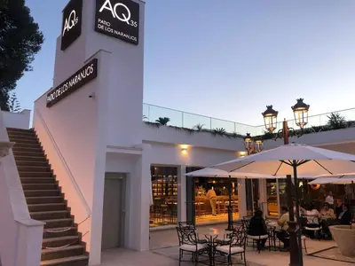 a restaurant with tables and umbrellas in front of a building at Hotel Jerez & Spa in Jerez de la Frontera