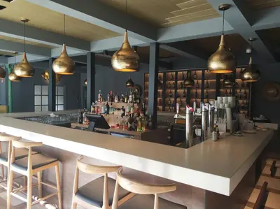 a bar in a restaurant with chairs and lights at Hotel Jerez & Spa in Jerez de la Frontera
