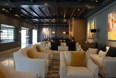 a lobby with white couches and a bar at Hotel Jerez & Spa in Jerez de la Frontera