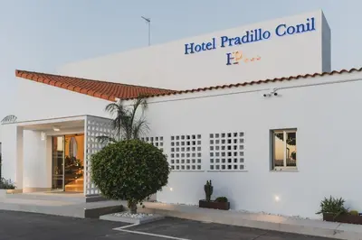 a white building with a sign that reads hotel probable condominium at Hotel Pradillo Conil in Conil de la Frontera