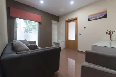 a living room with a couch and a window at Hotel Pradillo Conil in Conil de la Frontera