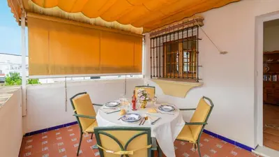 a dining room with a table and chairs at Apartamento Caracola Chipiona by Ruralidays in Chipiona
