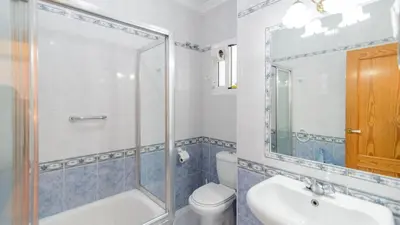 a bathroom with a shower and a toilet and a sink at Apartamento Caracola Chipiona by Ruralidays in Chipiona