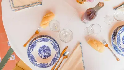 a table with blue and white plates and utensils at Apartamento Caracola Chipiona by Ruralidays in Chipiona