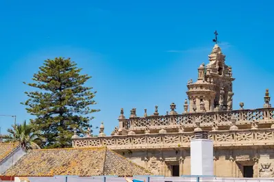 a pine tree on top of a building with a tower at Piso SieteRevueltas in Sanlúcar de Barrameda