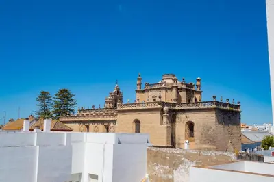 an old castle with a blue sky in the background at Piso SieteRevueltas in Sanlúcar de Barrameda