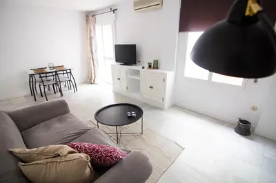 a living room with a couch and a table at Apartamento Albareda Centro in El Puerto de Santa María