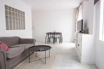 a living room with a couch and a table at Apartamento Albareda Centro in El Puerto de Santa María