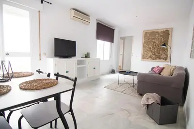 a living room with a table and a couch at Apartamento Albareda Centro in El Puerto de Santa María