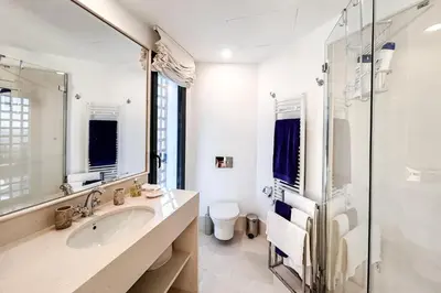 a white bathroom with a sink and a shower at Casa Vista Azul in El Puerto de Santa María