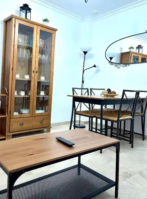 a room with a table and chairs and a dining room at Apartamento FEDUCHY 10 min de la playa 2 baños in Cádiz