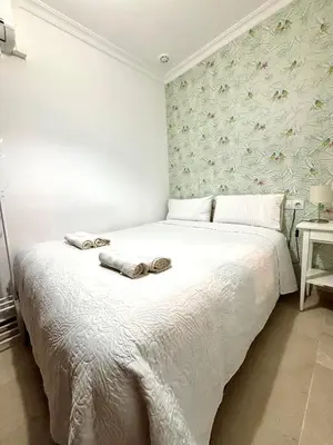 a bedroom with a bed with two towels on it at Apartamento FEDUCHY 10 min de la playa 2 baños in Cádiz