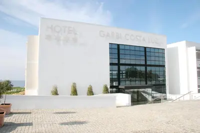 a building with a sign on the side of it at Garbí Costa Luz in Conil de la Frontera