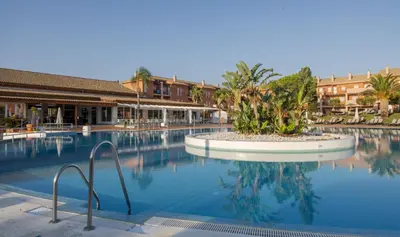 a large swimming pool in a resort with buildings at Ilunion Sancti Petri in Chiclana de la Frontera