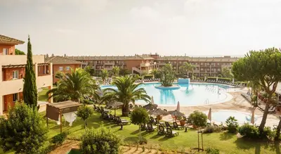 a resort with a large pool with tables and chairs at Ilunion Sancti Petri in Chiclana de la Frontera