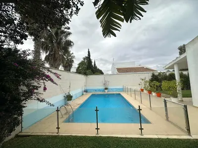 a swimming pool in the backyard of a house at Villa Los Pinares de Monaco en Roche, Conil, Cádiz in Conil de la Frontera