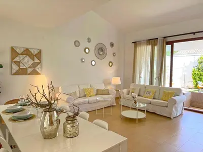 a living room with a couch and a table at Villa Los Pinares de Monaco en Roche, Conil, Cádiz in Conil de la Frontera