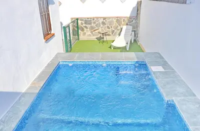 a swimming pool in the middle of a house at Chalet La Higuerita in Conil de la Frontera