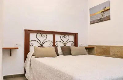 a bedroom with a large bed with two pillows at Chalet La Higuerita in Conil de la Frontera