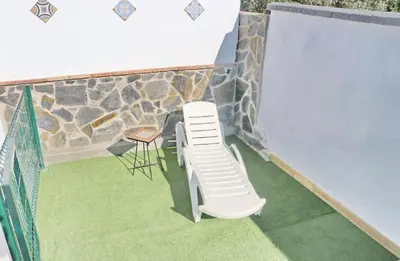 a balcony with a stack of chairs and a ladder at Chalet La Higuerita in Conil de la Frontera