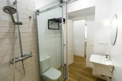 a bathroom with a shower and a sink at Apartamentos La Cruz Verde in Cádiz