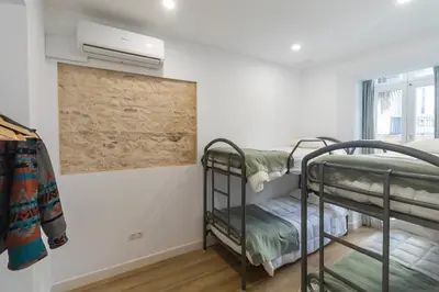 a room with two bunk beds and a window at Apartamentos La Cruz Verde in Cádiz