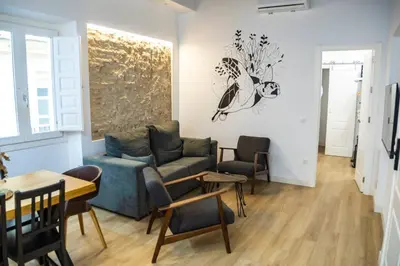 a living room with a couch and a table at Apartamentos La Cruz Verde in Cádiz
