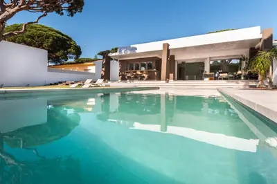 a swimming pool in front of a house at SIAT VIVIENDAS Villa carretera LA BARROSA in Chiclana de la Frontera
