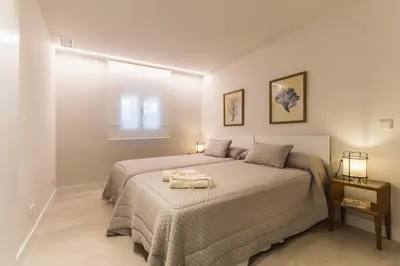 a bedroom with a bed with a towel on it at SIAT VIVIENDAS Villa carretera LA BARROSA in Chiclana de la Frontera