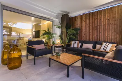 a living room with a couch and a table at SIAT VIVIENDAS Villa carretera LA BARROSA in Chiclana de la Frontera