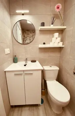 a bathroom with a toilet and a sink and a mirror at Suite San Mateos 15 in Jerez de la Frontera