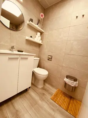 a bathroom with a toilet and a sink and a mirror at Suite San Mateos 15 in Jerez de la Frontera