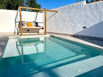 a swing sitting on top of a swimming pool at Minichalet El Molino 1 in Chiclana de la Frontera