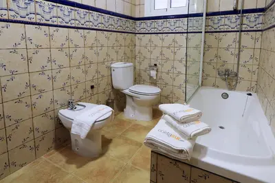 a bathroom with a toilet and a sink and a tub at Hacienda Laguna Seca - Apart. Jazmin in Chiclana de la Frontera