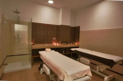a hospital room with two beds and a shower at Hotel Puerto Bahía & Spa in El Puerto de Santa María